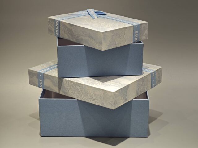 The boxes feature a blue and marbled pattern with a practical lift-off lid and are elegantly finished with blue ribbons.