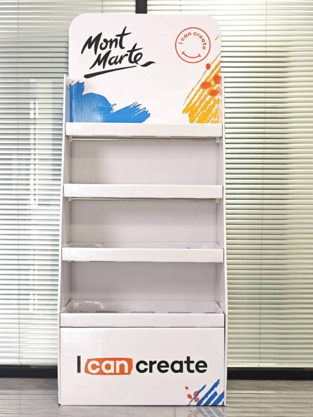 This image shows a custom box packaging design, featuring an empty white display stand. The top features the brand name, and the bottom includes a creative tagline. The display is set against a backdrop of vertical blinds, highlighting its sleek and modern presentation ideal for showcasing products. Instead of actual text on the packaging, think of it as conceptual placeholders that emphasize brand identity and messaging opportunities in product displays.