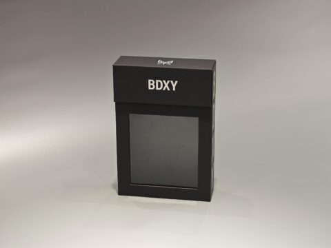 The product is a sleek, black rectangular custom packaging box designed to meet diverse packaging needs. It features a minimalist and sophisticated style, complemented by its neutral background. The box can be customized with logos or brand elements according to client specifications.